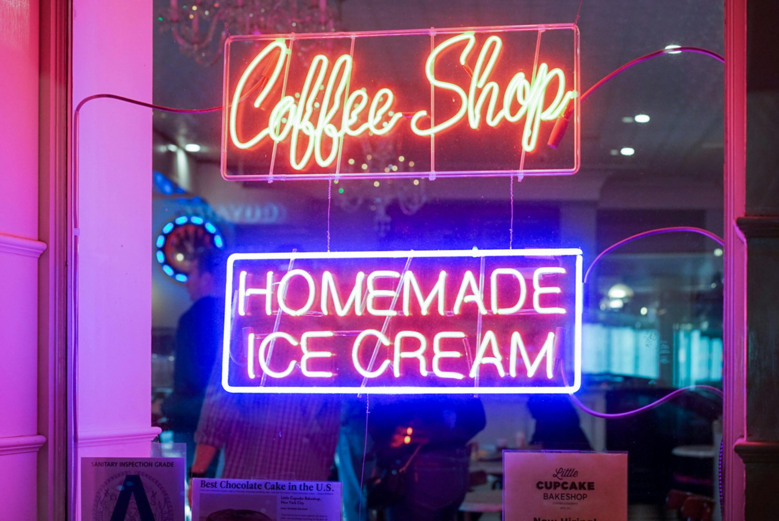 Modern LED illuminated storefront sign attracting customers at night
